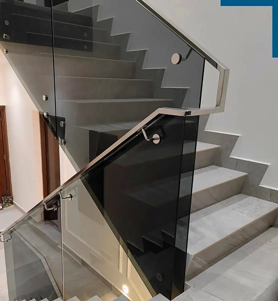 Glass staircase balustrade with steel handrail
