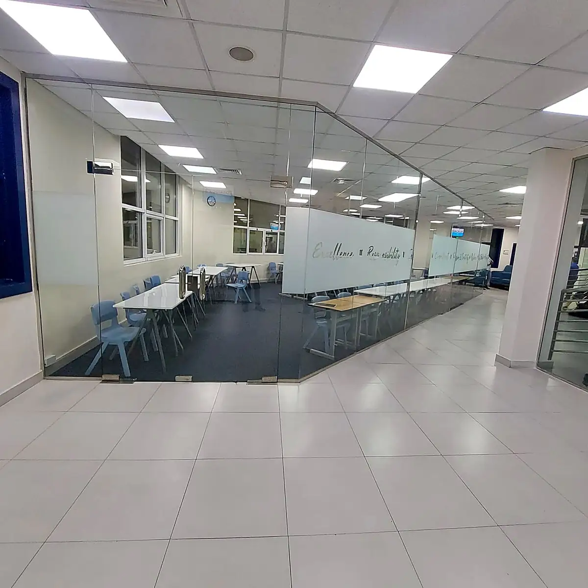 Glass-partitioned office corridor