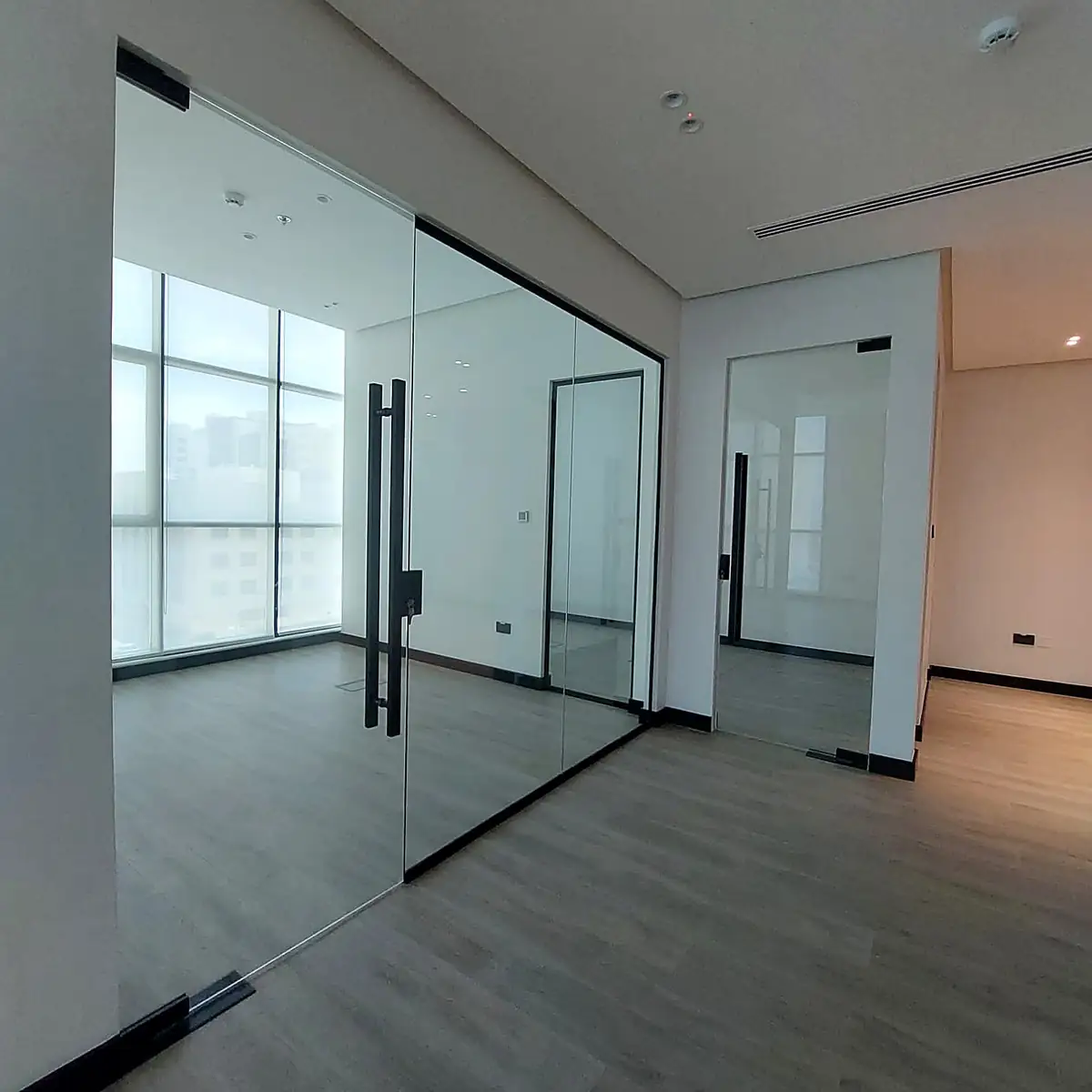Bright office with glass partition doors