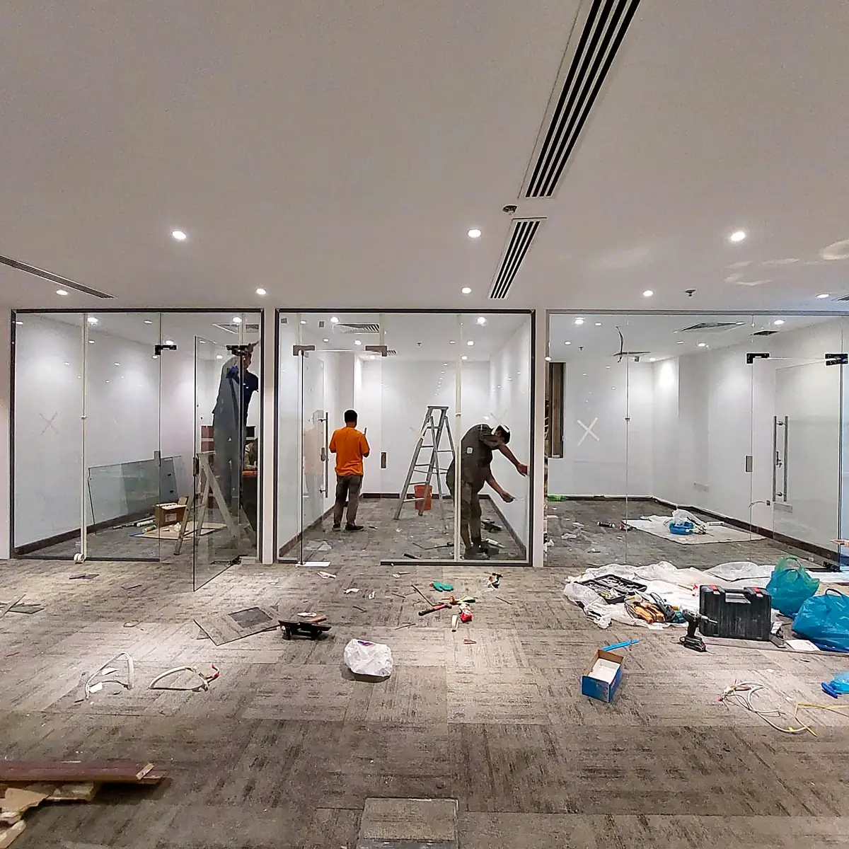 BD Glass team fitting glass partitions on site